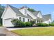 Charming two-story home with white siding, black shutters, and manicured landscaping at 506 Brewer Dr, Locust Grove, GA 30248