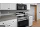 Well-equipped kitchen features modern stainless steel appliances and white cabinetry at 506 Brewer Dr, Locust Grove, GA 30248