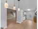 Open kitchen showcasing pendant lighting and stainless steel appliances at 506 Brewer Dr, Locust Grove, GA 30248