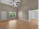 Expansive living room with soaring ceilings, wood flooring, and large windows at 506 Brewer Dr, Locust Grove, GA 30248