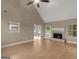 Spacious living room features a fireplace, a ceiling fan, and wood flooring at 506 Brewer Dr, Locust Grove, GA 30248