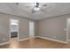 Spacious main bedroom with tray ceiling, ceiling fan, and ensuite bathroom entrance at 506 Brewer Dr, Locust Grove, GA 30248