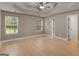 Spacious main bedroom featuring a tray ceiling, ceiling fan, and generous windows with views at 506 Brewer Dr, Locust Grove, GA 30248