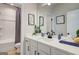 Well-lit bathroom features a single sink vanity, modern fixtures, framed art and a shower-tub combo at 43 Avian Way # 3B, Auburn, GA 30011