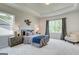 Relaxing bedroom with large windows, neutral tones, and a cozy sitting area at 43 Avian Way # 3B, Auburn, GA 30011