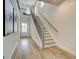 Inviting foyer with hardwood floors, a staircase leading to the second floor, and a view of the front door at 43 Avian Way # 3B, Auburn, GA 30011