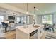 Bright kitchen island features quartz countertops, a modern faucet, and stainless steel appliances in an open-concept space at 43 Avian Way # 3B, Auburn, GA 30011