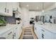 Modern kitchen with white cabinetry, stainless steel appliances, and a sleek backsplash at 43 Avian Way # 3B, Auburn, GA 30011