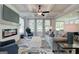 Comfortable living room with a fireplace, area rug, and view into the screened porch at 43 Avian Way # 3B, Auburn, GA 30011