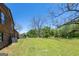 Expansive backyard with lush greenery and mature trees, providing a serene and private setting at 1919 101 S Hwy, Temple, GA 30179