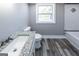 Bathroom featuring a granite vanity, toilet, and tub/shower combination with decorative tile at 1919 101 S Hwy, Temple, GA 30179