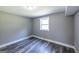 Bedroom featuring gray walls, hardwood floors, and a bright, sunny window at 1919 101 S Hwy, Temple, GA 30179