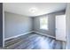Bedroom featuring gray walls, hardwood floors, and a bright, sunny window at 1919 101 S Hwy, Temple, GA 30179