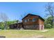 Charming two-story home with a blend of wood and brick, complemented by a lush green lawn at 1919 101 S Hwy, Temple, GA 30179