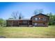 Charming two-story home with a brick and wood facade, front porch, and well-maintained lawn at 1919 101 S Hwy, Temple, GA 30179