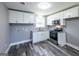 Modern kitchen area featuring white cabinets, granite countertops, stainless steel appliances, and modern fixtures at 1919 101 S Hwy, Temple, GA 30179