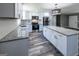 Stylish kitchen boasting white cabinets, granite countertops, stainless steel appliances, and wood flooring at 1919 101 S Hwy, Temple, GA 30179