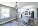 Bright kitchen with white cabinets, stainless steel appliances, granite countertops and modern pendant lights at 1919 101 S Hwy, Temple, GA 30179