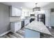 Modern kitchen featuring white cabinets, stainless steel appliances, granite countertops, and stylish pendant lighting at 1919 101 S Hwy, Temple, GA 30179