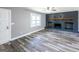 Bright living room featuring modern gray walls, wood flooring, and a striking black brick fireplace at 1919 101 S Hwy, Temple, GA 30179