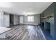 Large living area featuring a black brick fireplace, wood floors, and an open concept design at 1919 101 S Hwy, Temple, GA 30179