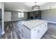 Inviting living room featuring gray walls, hardwood floors, fireplace and kitchen island at 1919 101 S Hwy, Temple, GA 30179