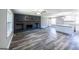 Open-concept living room with gray walls, wood floors, and a modern kitchen with white cabinets at 1919 101 S Hwy, Temple, GA 30179