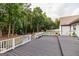 Spacious back deck with built-in benches and white railings overlooking a lush backyard with playground at 870 Rutherford Dr, Dacula, GA 30019
