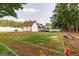 Wide view of the large backyard showcasing the custom football field, mature trees, and deck areas at 870 Rutherford Dr, Dacula, GA 30019