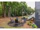 Lush backyard with a stone fire pit, seating area, and a playground, offering plenty of space to relax at 870 Rutherford Dr, Dacula, GA 30019