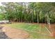 Full backyard view of the football field, trees, and playground in a well-manicured outdoor space at 870 Rutherford Dr, Dacula, GA 30019