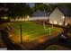 Backyard with a custom-built football field, well-manicured lawn and a fenced perimeter at 870 Rutherford Dr, Dacula, GA 30019