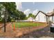 Spacious backyard with a custom football field, mature trees, and a well-maintained lawn at 870 Rutherford Dr, Dacula, GA 30019