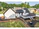 Aerial view of modern home with football field, deck, and black mulch in backyard at 870 Rutherford Dr, Dacula, GA 30019