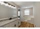Bathroom boasts double vanity, a separate tub, and wood-look flooring at 870 Rutherford Dr, Dacula, GA 30019