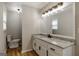 Bright bathroom features granite countertops, a large mirror, and a separate toilet area at 870 Rutherford Dr, Dacula, GA 30019