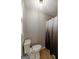 Cozy half bathroom with wood-look flooring and a shower with a decorative curtain at 870 Rutherford Dr, Dacula, GA 30019