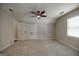 Large bedroom with a ceiling fan, neutral carpet, and closets for storage at 870 Rutherford Dr, Dacula, GA 30019