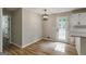 Cozy dining area near kitchen features stylish lighting, wood-look floors, and outdoor access at 870 Rutherford Dr, Dacula, GA 30019