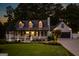 Inviting home exterior featuring a charming front porch, well-manicured lawn and professional landscaping at 870 Rutherford Dr, Dacula, GA 30019