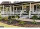 Welcoming front entrance with flower planters, decorative touches, and a manicured flowerbed at 870 Rutherford Dr, Dacula, GA 30019