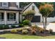 Well-maintained home exterior with beautiful landscaping, mulch beds, and inviting front porch at 870 Rutherford Dr, Dacula, GA 30019
