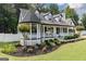 Landscaped yard featuring flower beds, shrubs, and a well-maintained lawn at 870 Rutherford Dr, Dacula, GA 30019
