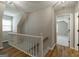 Spacious second story hallway with a stairway and an open bedroom doorway at 870 Rutherford Dr, Dacula, GA 30019