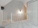 Hallway overlooking room with neutral paint and carpet and white railing and doors at 870 Rutherford Dr, Dacula, GA 30019