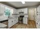 Renovated kitchen features white cabinets, granite countertops, stainless steel appliances, and stylish fixtures at 870 Rutherford Dr, Dacula, GA 30019