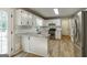 Bright kitchen features white cabinets, granite countertops, stainless steel appliances, and wood-look floors at 870 Rutherford Dr, Dacula, GA 30019