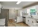 Updated kitchen boasts granite countertops, stainless steel appliances, wood-look floors, and ample cabinet space at 870 Rutherford Dr, Dacula, GA 30019