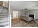 Cozy living room with hardwood flooring, fireplace, and staircase at 870 Rutherford Dr, Dacula, GA 30019