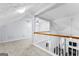 A carpeted bonus room/attic space with wood and white railing and ample sunlight at 11765 Fairway Overlook, Fayetteville, GA 30215